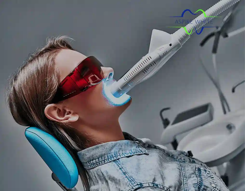 Patient relaxing in clinic chair during 1 hour laser teeth whitening session High Wycombe